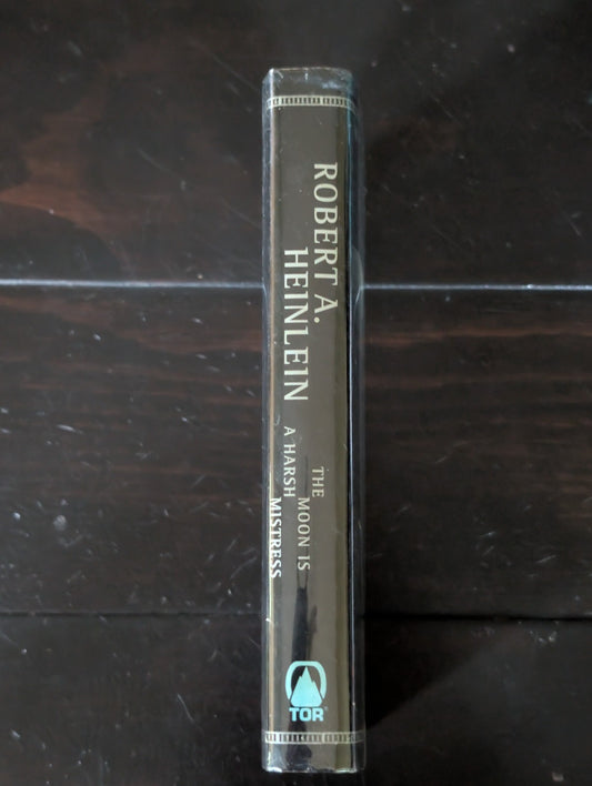 Moon Is a Harsh Mistress by Robert A. Heinlein (1996, Hardcover) -JD