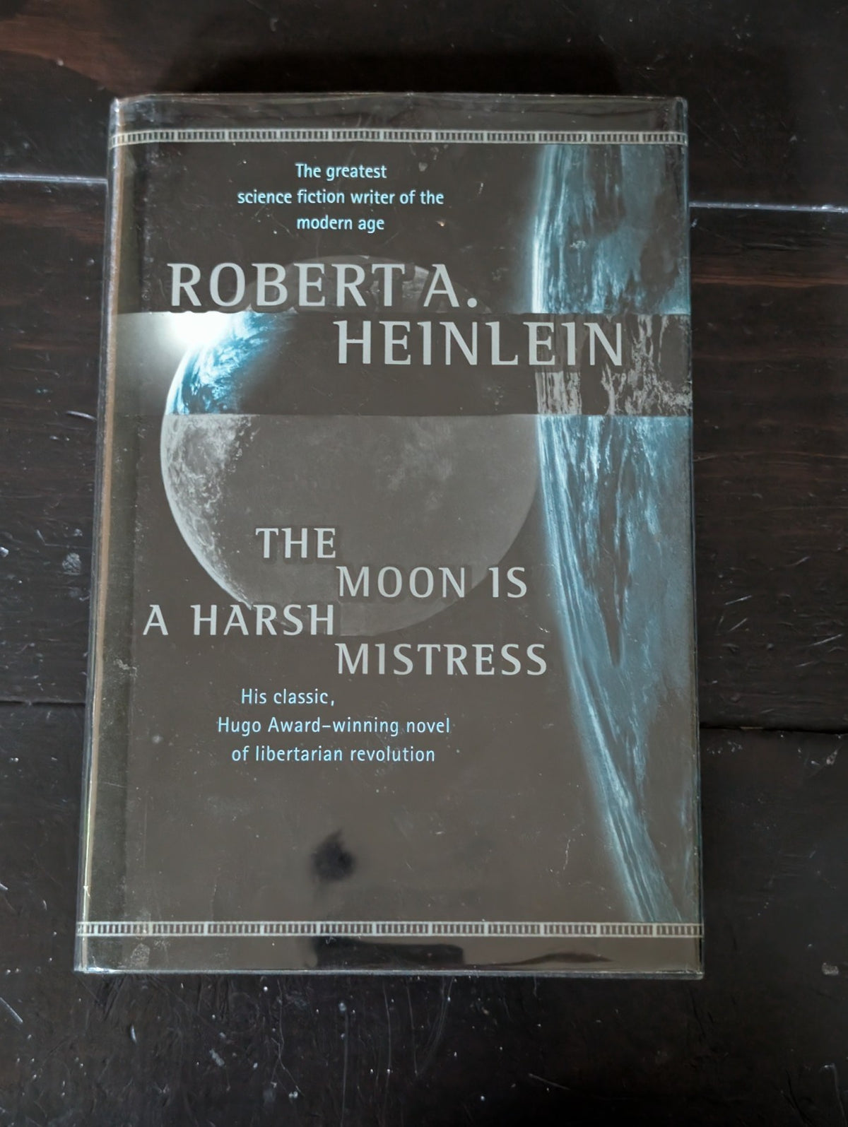 Moon Is a Harsh Mistress by Robert A. Heinlein (1996, Hardcover) -JD